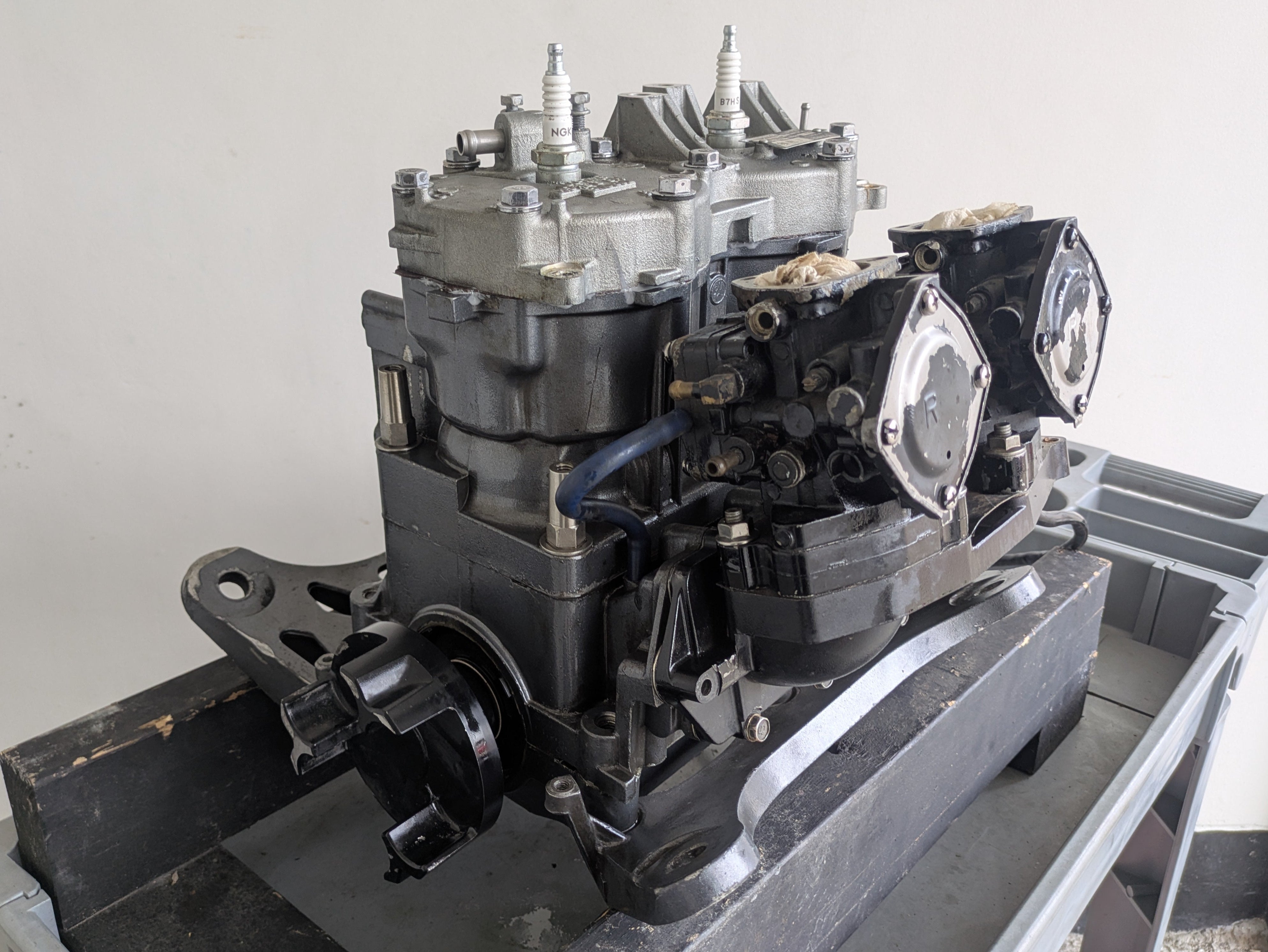 Mechanical engine block on a stand against a plain background